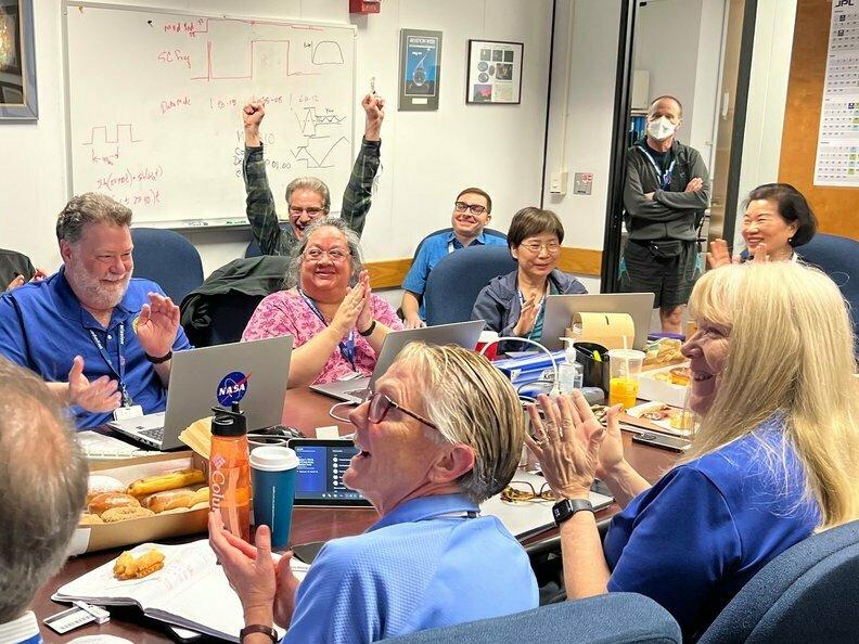 Members of the Voyager team celebrate at NASA's Jet Propulsion Laboratory after receiving data about the health and status of Voyager 1 for the first time in months.
