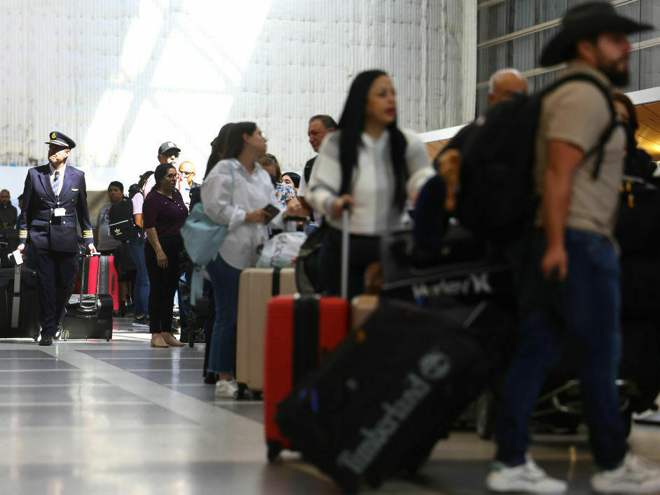 Travelers and their luggage in a terminal at Los Angeles International Airport in August 2023.