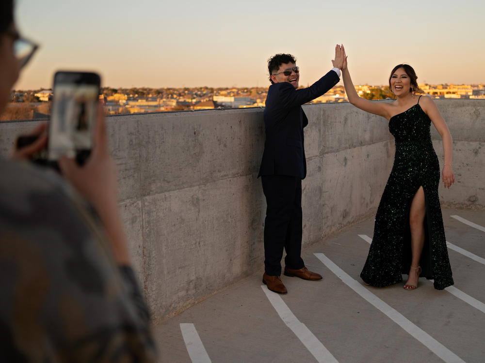 Eddie Almance (left) and his sister Leila pose for their cousin Ailem Villarreal on the rooftop of the Marriott Hotel in downtown Odessa, Texas, before heading to prom. Their grandmother says that for seven generations, the family members have forged close bonds.