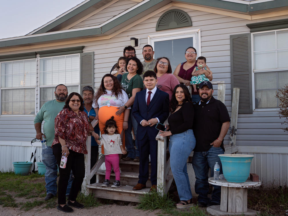 Caitlynn Almance (wearing orange) poses for a portrait with family members at her parents' home in Odessa, Texas. 