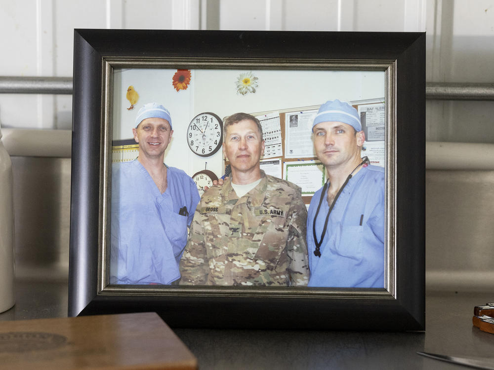 A photo of Rasmussen (left) with U.S. Army Col. Dr. Kirby Gross and then-Lt. Col. Dr. Joseph DuBose at the Air Force Theater Hospital on Bagram Air Base in Afghanistan in 2012.