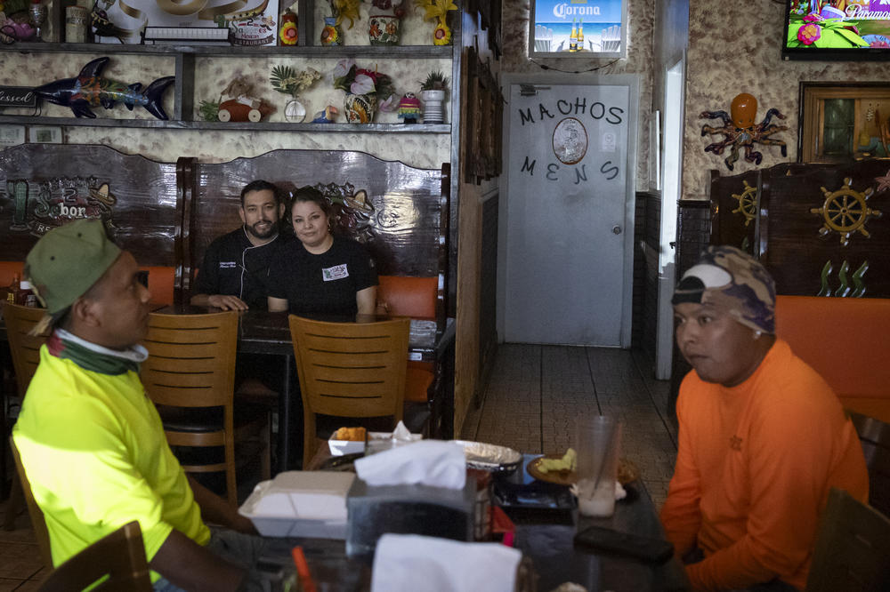 Ramiro Ruiz, chef and owner of 2 Sabores Mexican restaurant, poses for a photo with his wife at their restaurant in Fort Myers, Fla., in February.