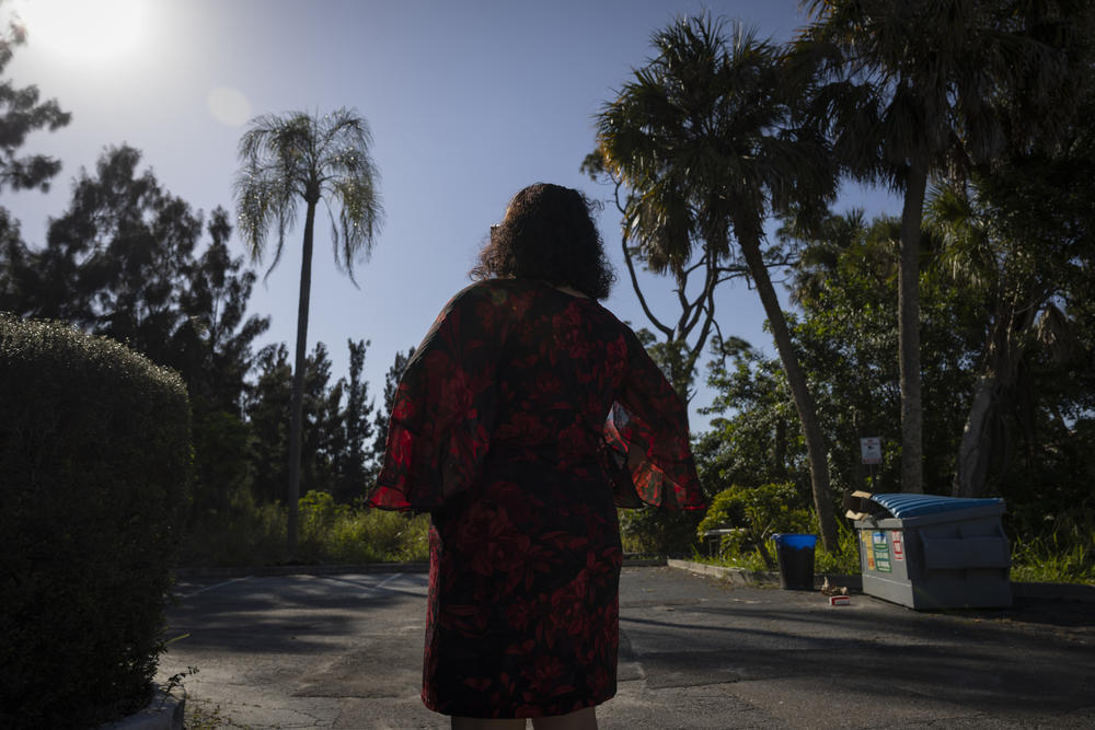A woman who drives migrants across the country poses for a portrait in Fort Myers, Fla., in February.