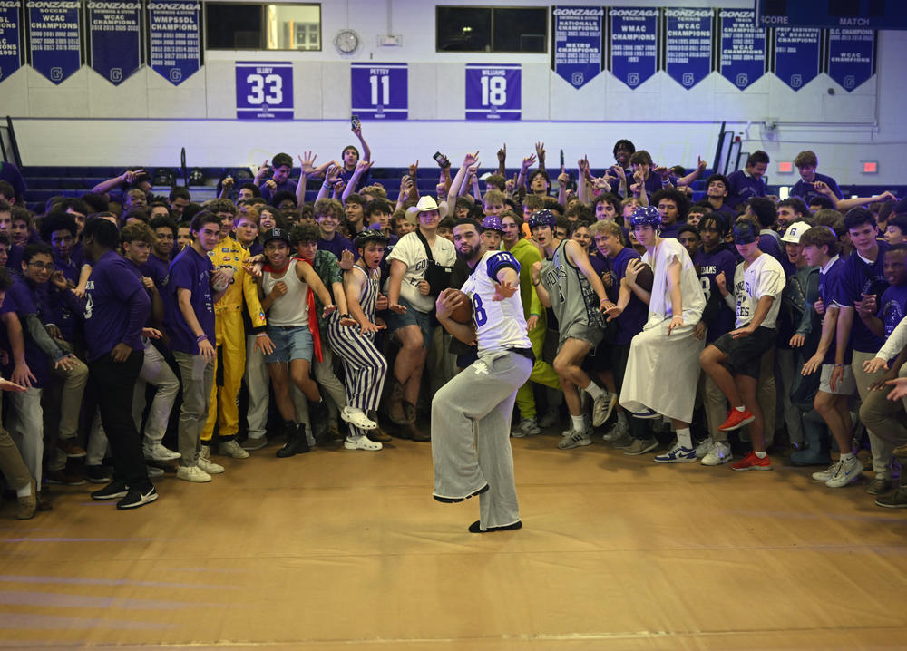 Heisman Trophy winner Caleb Williams visited his high school alma mater Gonzaga to attend a pep rally to honor the USC quarterback for his award. Williams, center strikes a Heisman pose along with members of the student body in the school's gym on May 19, 2023 in Washington, DC.