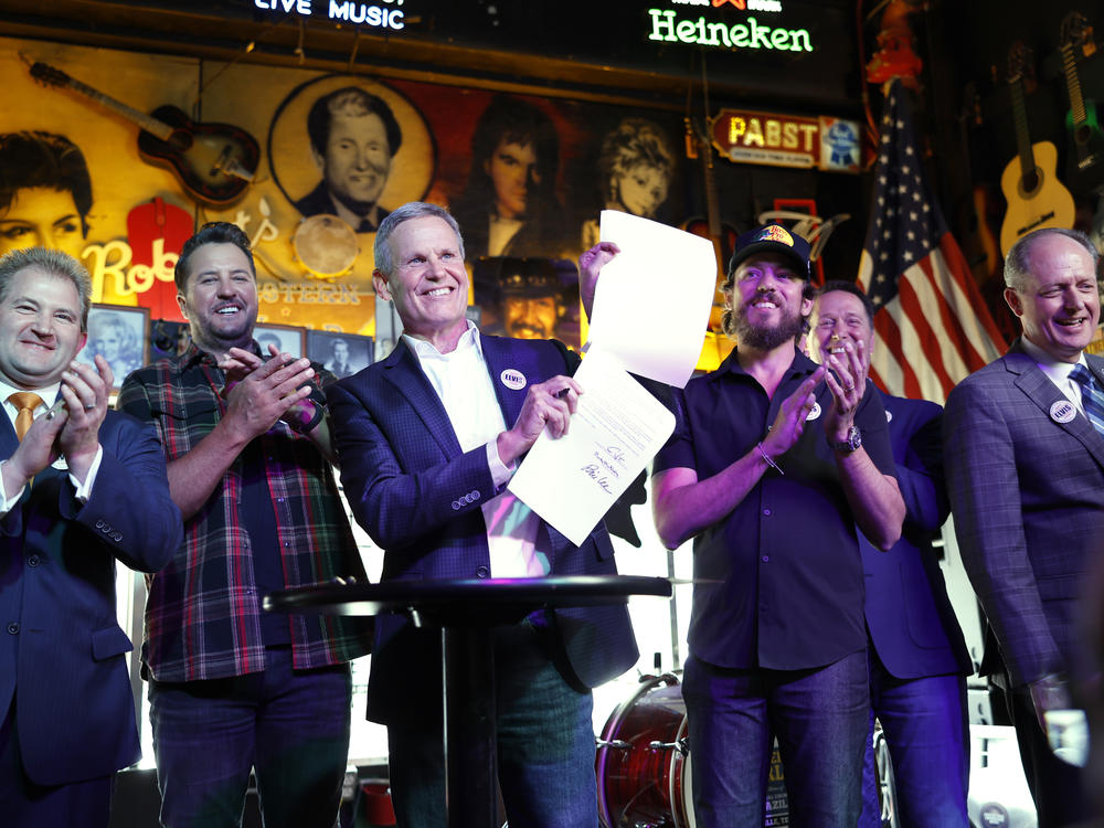 Lawmakers and supporters pose at the signing of the ELVIS Act at Robert's Western World in Nashville on March 21, 2024. Left to right: Representative William Lamberth, musician Luke Bryan, Governor Bill Lee, musician Chris Janson, RIAA head Mitch Glazier and Senator Jack Johnson.