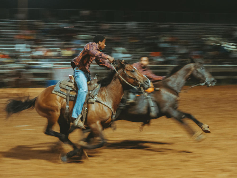Riders pass a baton during a Pony Express relay race in Okmulgee, Okla.