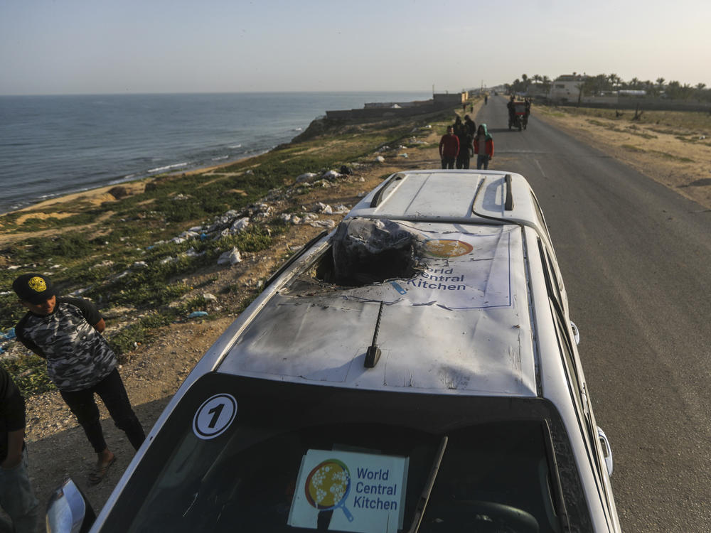 Palestinians inspect a vehicle with the logo of the World Central Kitchen wrecked by an Israeli airstrike in Deir al Balah, Gaza, on April 2, 2024. A memorial at the National Cathedral in Washington on April 25 will honor the seven WCK workers killed in the attack.