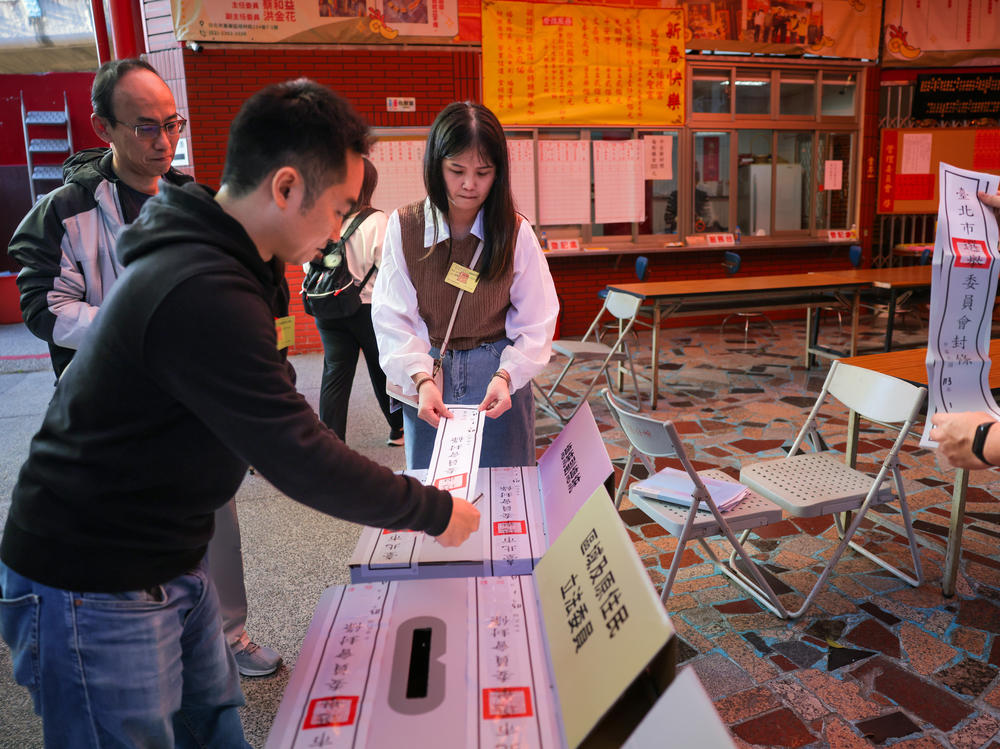 Election workers in Taipei, Taiwan, inspect boxes containing ballots as counting got underway on Jan. 13, 2024. China unsuccessfully sought to influence Taiwan's elections via social media, including TikTok.