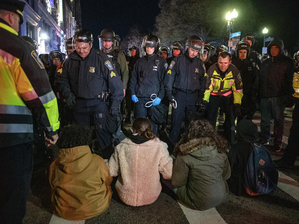 Boston police move to arrest pro-Palestinian supporters who were blocking the road after the clearing of Emerson College's encampment early Thursday morning.