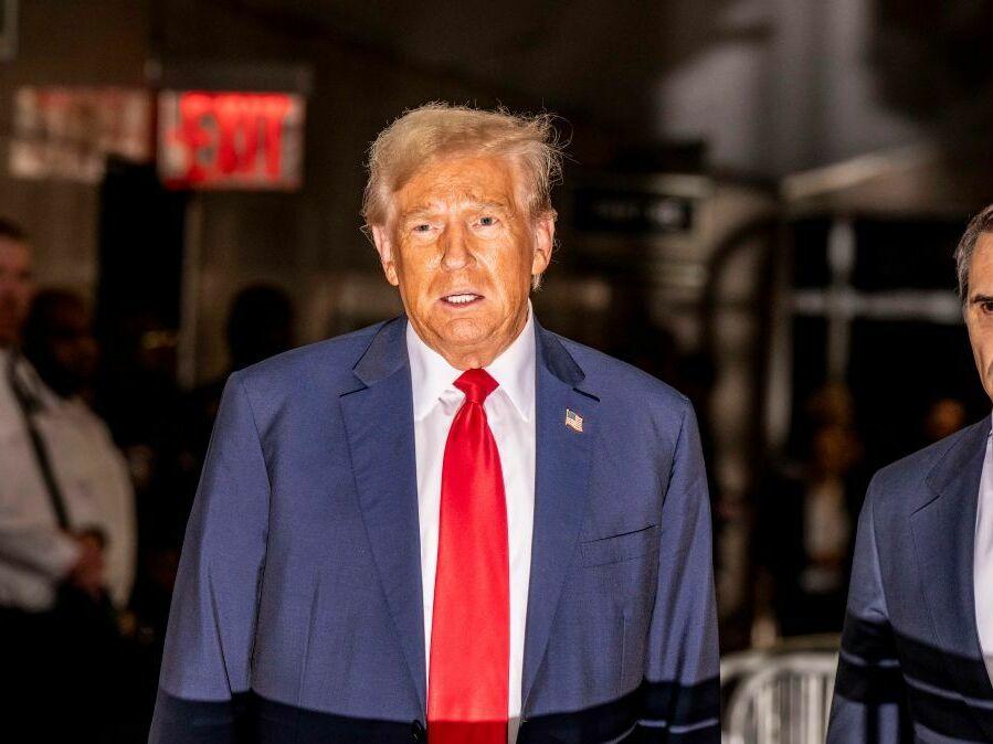 Former President Trump talks to reporters after his hush-money trial in New York adjourned for the day Thursday.