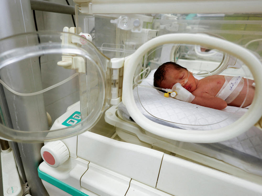 A Palestinian baby girl, saved from the womb of her mother Sabreen Al-Sakani, who was killed in an Israeli strike along with her husband Shukri Jouda and her daughter Malak, lies in an incubator at the Emirati hospital in Rafah in the southern Gaza Strip, April 21.