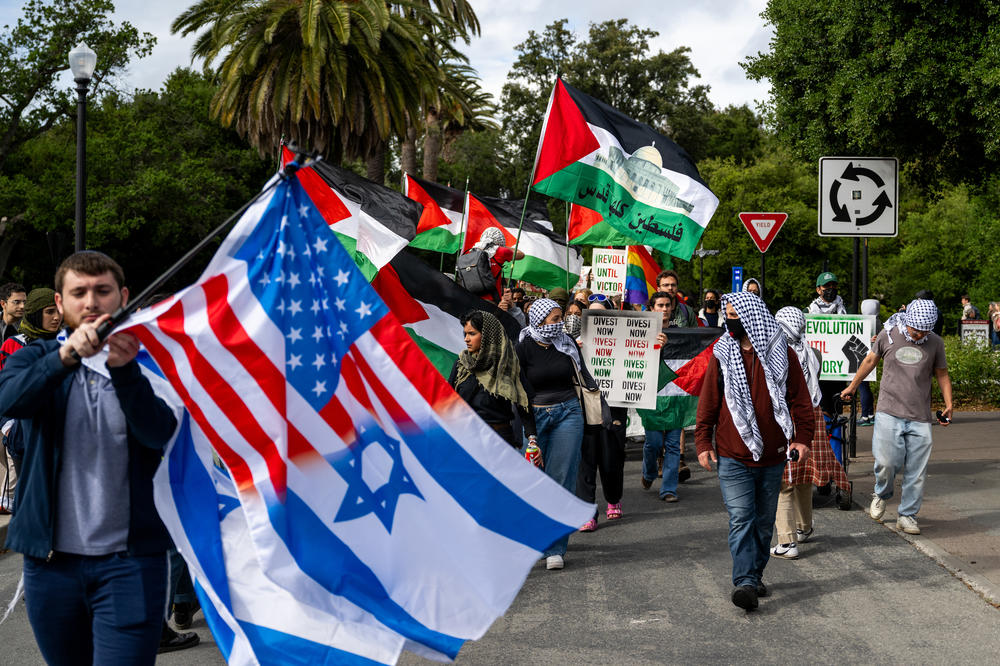A pro-Israel counter-protester waves an Israel flag during a pro-Palestinian march through the Stanford University campus in Stanford, Calif., on April 25, 2024, calling for the university to divest from Israel. The rally took place during Stanford's Admit Weekend, a time for incoming students to tour the university.