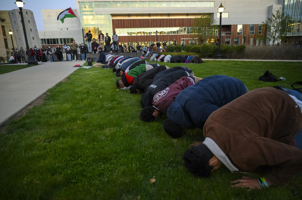 As the sun sets, Muslim protestors pray during a rally on campus at the University of Connecticut calling for the university to divest from companies they say are playing a role in the Israel-Hamas war. One person was arrested as several hundred people attended the event April 25, 2024.
