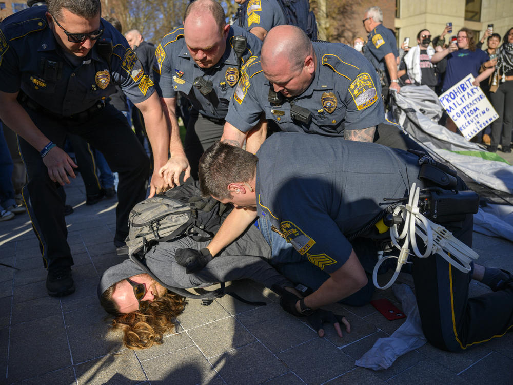 A University of Connecticut student is arrested during a rally on campus calling for the university to divest from companies they say are playing a role in the Israel-Hamas war. More than 150 people attended the event April 25, 2024.