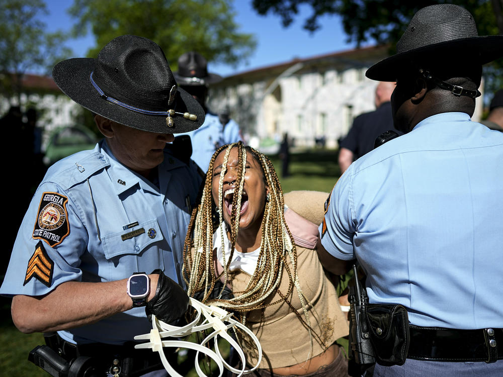 Georgia State Patrol officers detain a demonstrator on the campus of Emory University during a pro-Palestinian demonstration on Thursday, April 25 in Atlanta.