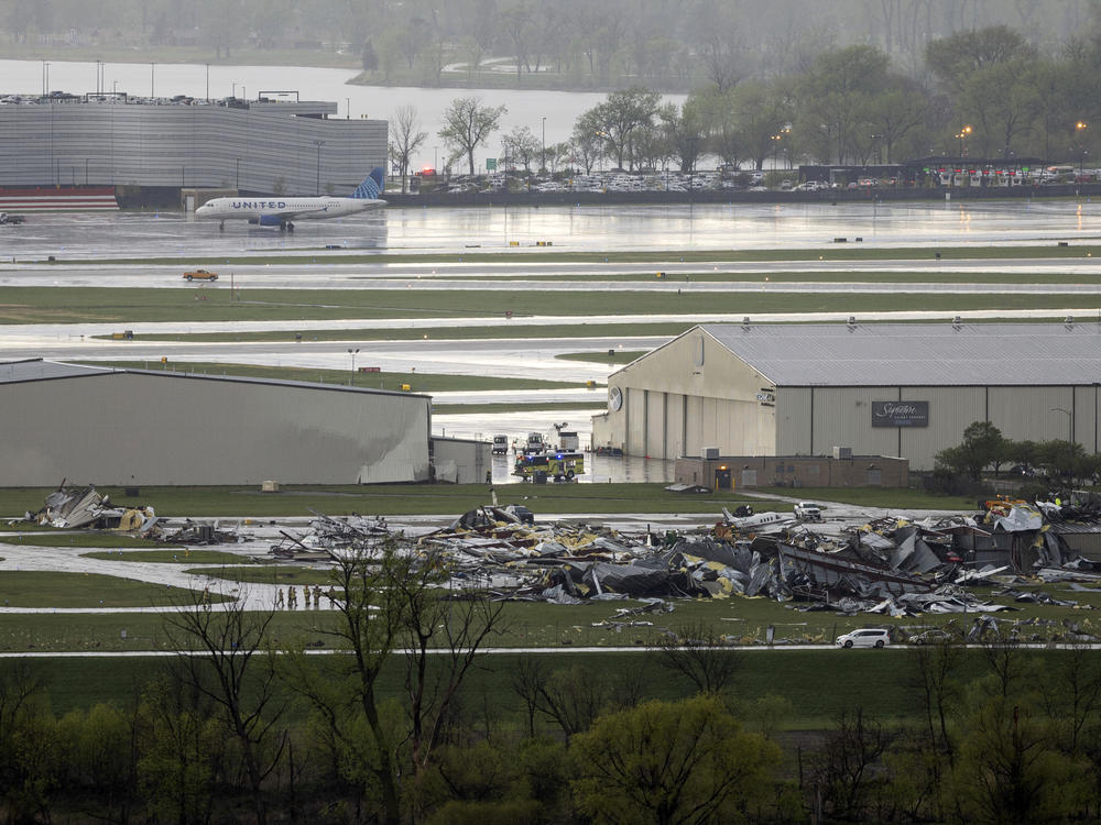 Severe weather damage to Eppley Airfield in Omaha, Neb., can be seen from the Lewis and Clark Monument in Council Bluffs, Iowa on Friday