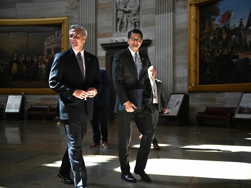 Former House Speaker Paul Ryan (right) and then-House Speaker Kevin McCarthy walk through the Capitol rotunda on May 17, 2023.
