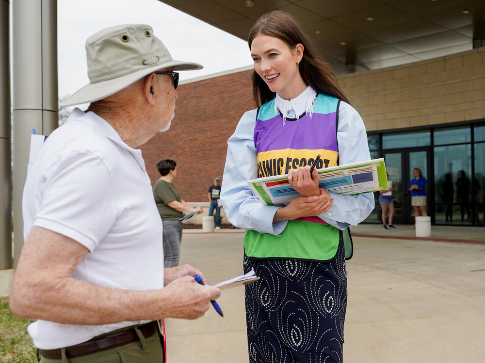 Karlie Kloss, right, speaks to a volunteer for Missourians for Constitutional Freedom, a group attempting to legalize abortion in the state, on Monday, April 1, 2024, at Congregation Shaare Emeth in Creve Coeur, Mo.