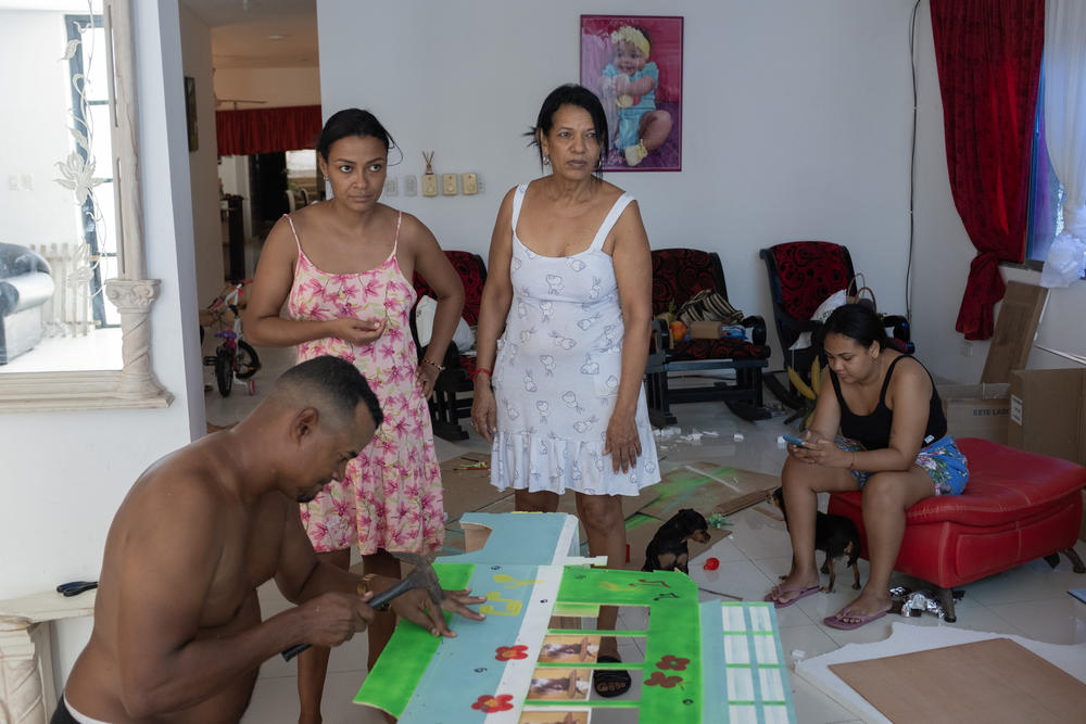 People spend days, and a lot of money, putting together costumes for thier donkeys. This family is building a small bus to place on top of their donkey for the costume competition.