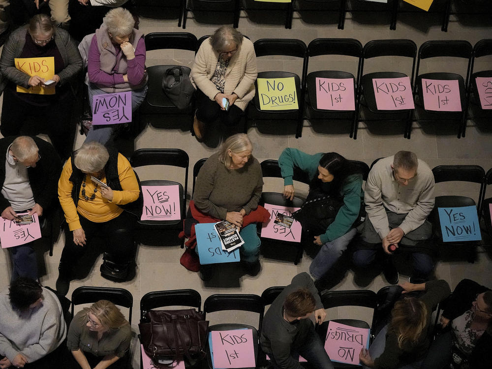 Supporters of Missouri's ban on gender-affirming care for minors gather on the floor of the statehouse in Jefferson City in March 2023.