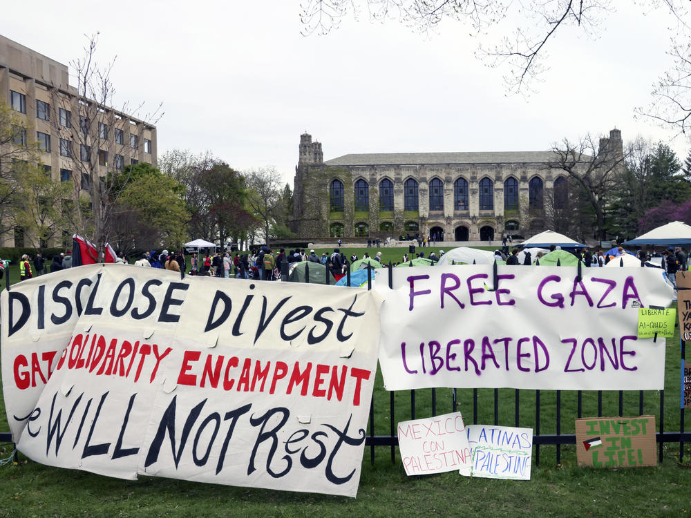 Signs are displayed outside a tent encampment at Northwestern University on Friday in Evanston, Illinois. Students and the university reached a deal Monday, allowing the demonstrations to continue, but that mandated the removal of all but one of these tents.