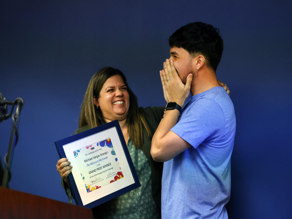 Professor Emily Sendin of Miami Dade College (L) presents Michael Vargas Arango (R) with the winner certificate from the NPR Podcast Challenge.