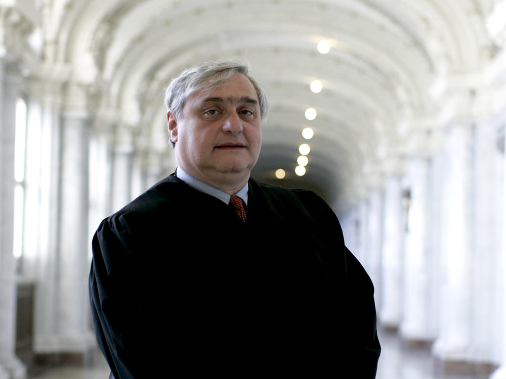 Alex Kozinski, then-chief judge on the U.S. 9th Circuit Court of Appeals, stand inside the James L. Browning Courthouse in San Francisco in 2009.