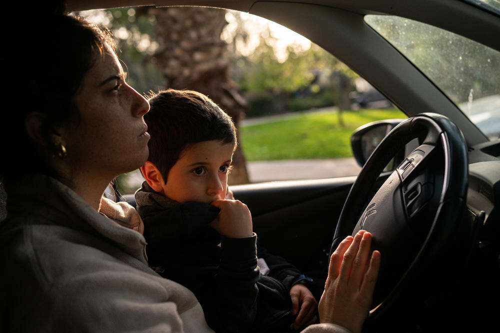 Elan Tiv drives a short distance home with her five-year-old son Hadar after going for a walk on March 26 with her older daughter and her mother, Aviva Siegel, on Kibbutz Gazit, the community where she lives in northern Israel. 