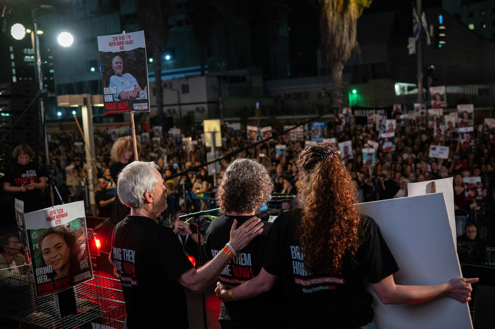 Aviva Siegel is supported by Keith's brother, Lee, 72, and her daughter Shir, 28, as she speaks at the weekly rally supporting the hostages and their families in Tel Aviv, on March 30. 