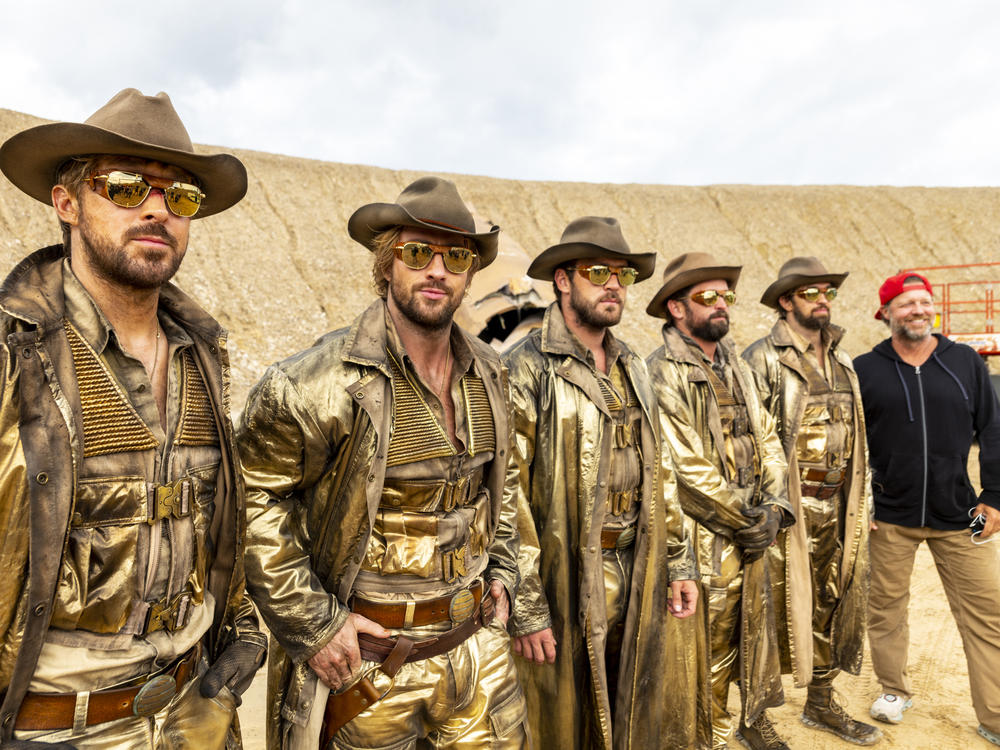 Ryan Gosling, Aaron Taylor-Johnson, Ben Jenkin, Logan Holladay, and Justin Eaton, along with director David Leitch on set.
