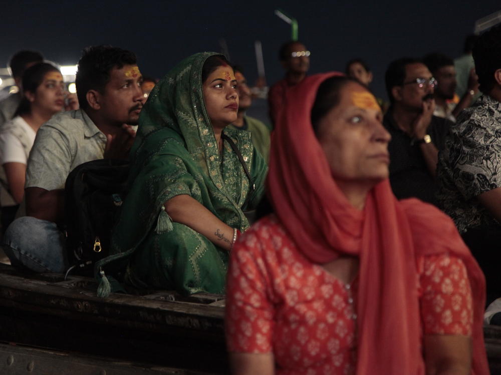 Worshippers and tourists sit on boats facing the bank of the Ganges River in the holy Hindu city of Varanasi to watch the Ganga Aarti, a ritual of devotion to the venerated river. Hindu priests wave fire as the sun sets, ring bells and tap on drums. Thousands watch, clap and chant along from boats crammed in the water.