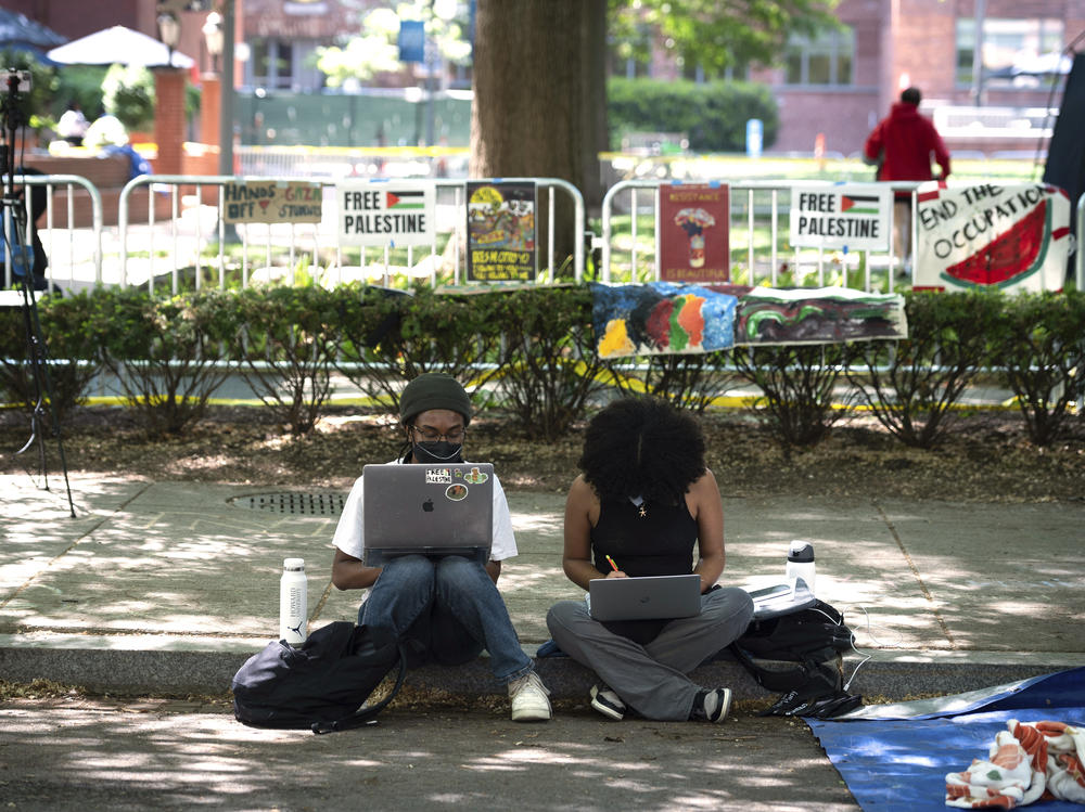 Students work on their class assignments from a demonstration at George Washington University on Sunday.