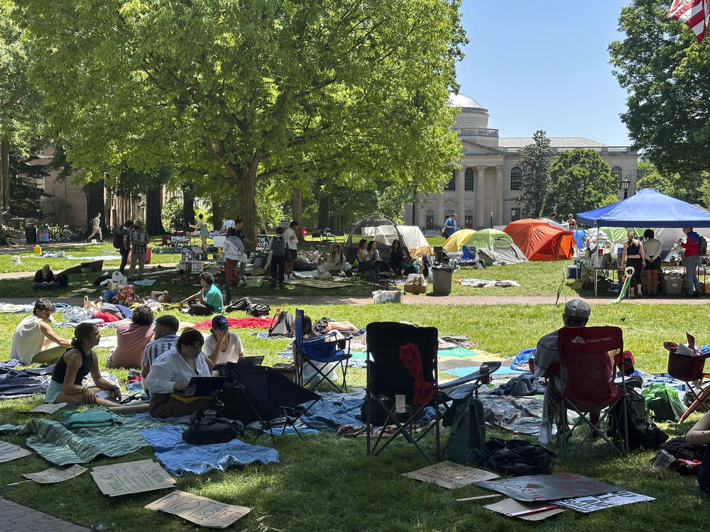 Students work on assignments and listen to organizers as they sit inside the encampment protest in Polk Place on University of North Carolina at Chapel Hill, N.C., on Monday.
