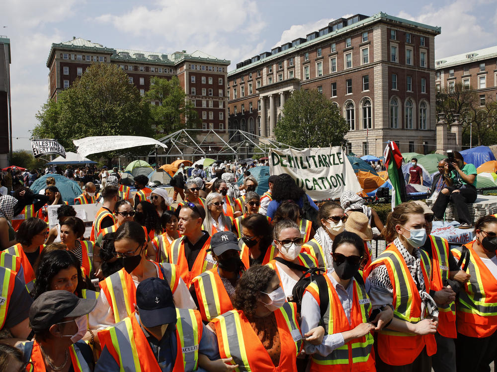Columbia University faculty and staff gather on the campus in solidarity with student protesters on Monday.