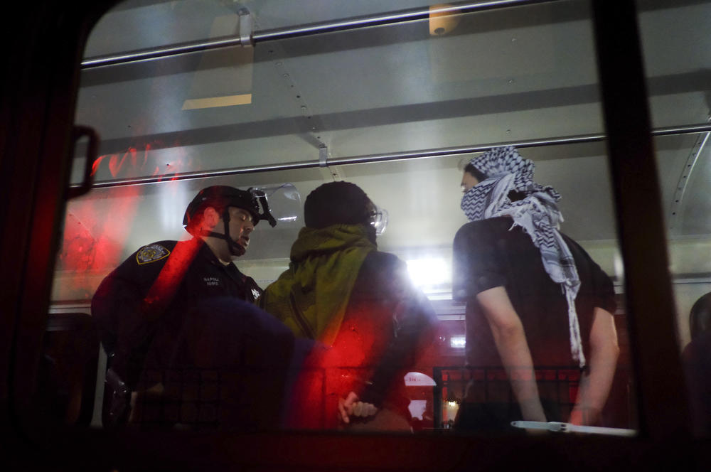 Members of the New York Police Department strategic response team load arrested protesters from Columbia University onto a bus, Tuesday, April 30, 2024, in New York.
