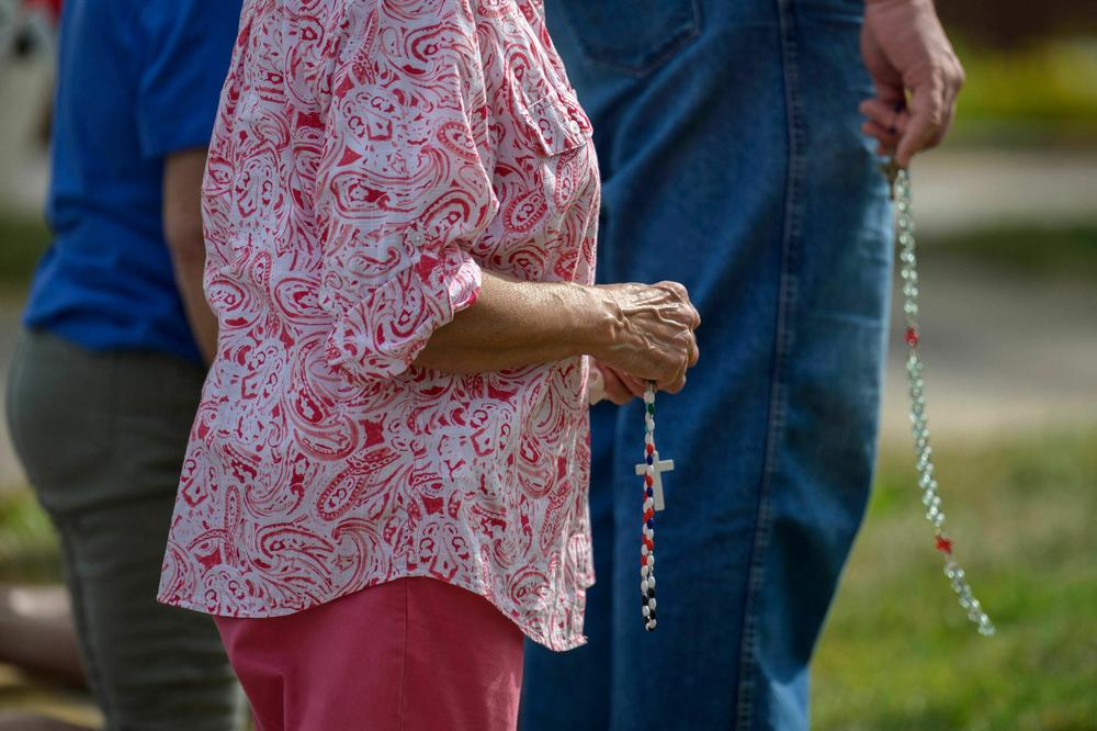 Anti-abortion activists hold rosaries and pray outside a clinic that provides abortion services.
