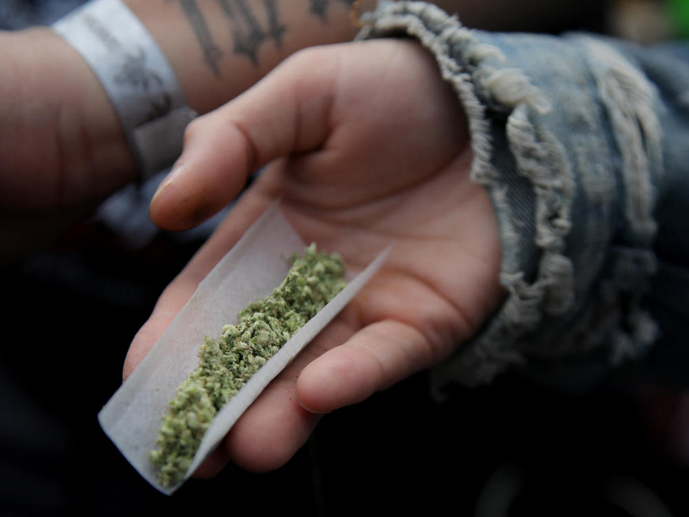 A person prepares a marijuana cigarette in New York City on April 20, 2024.