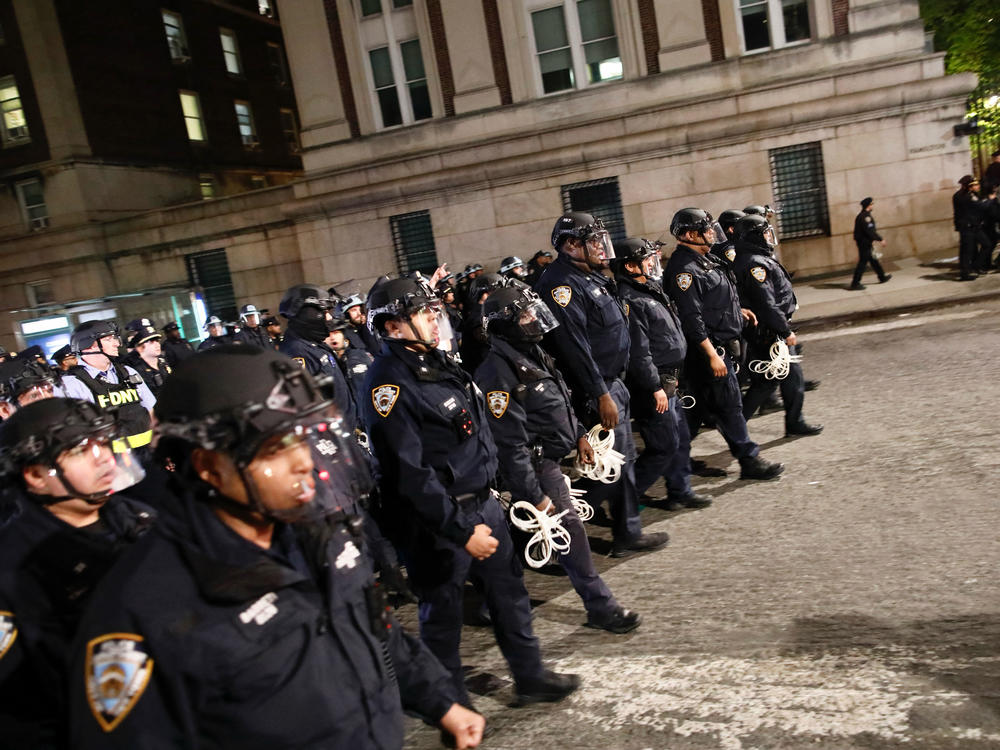 NYPD officers in riot gear march onto Columbia University campus, where pro-Palestinian students are barricaded inside a building and have set up an encampment, in New York City on April 30, 2024.