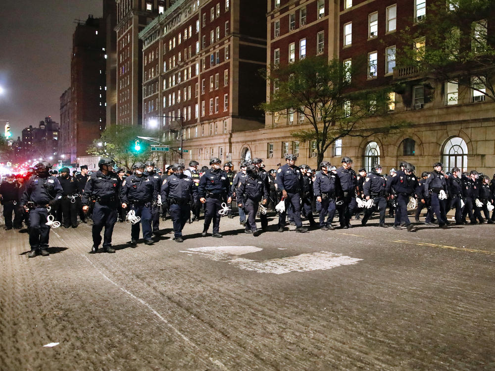 NYPD officers in riot gear march onto Columbia University campus, where pro-Palestinian students are barricaded inside a building and have set up an encampment, in New York City on April 30, 2024.