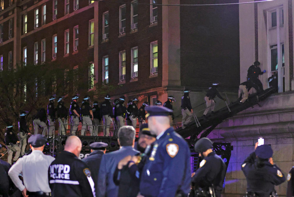 NYPD officers in riot gear break into a building at Columbia University, where pro-Palestinian students are barricaded inside a building and have set up an encampment, in New York City on April 30, 2024.