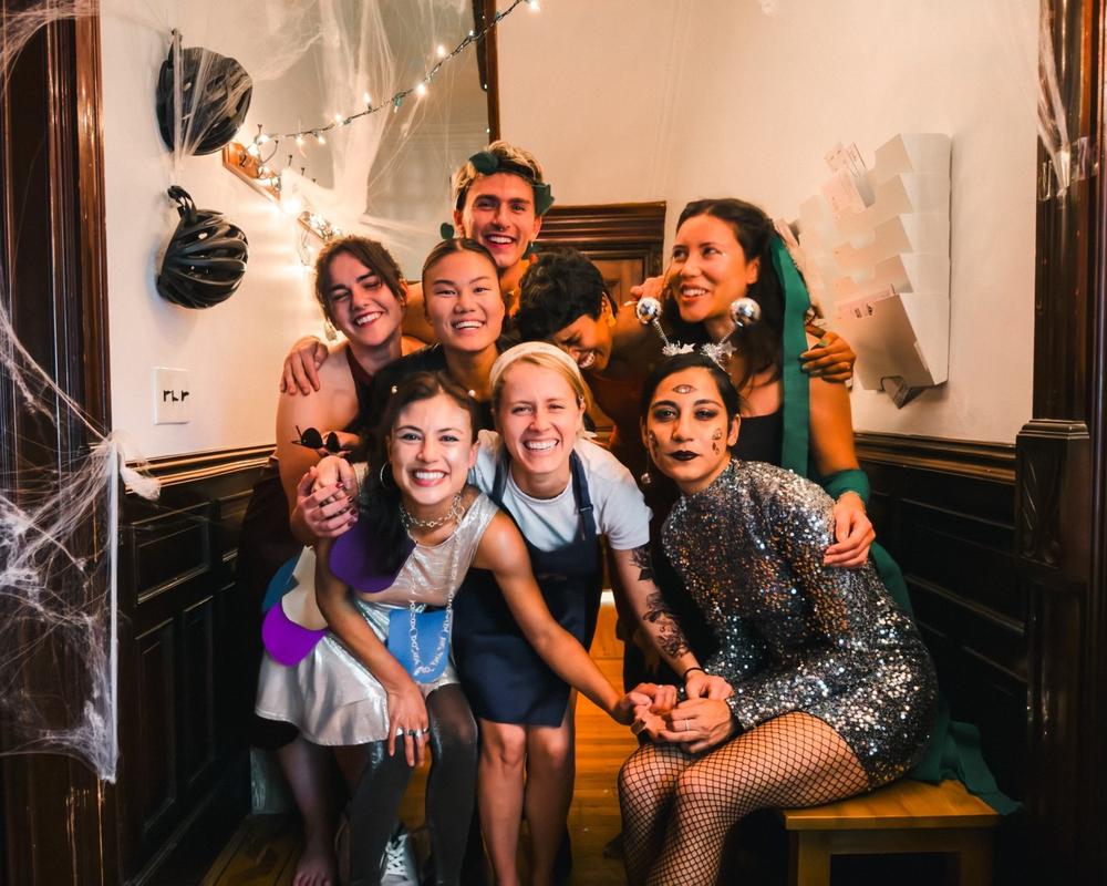 Sindhu Gnanasambandan at a Halloween party with her housemates at their group house in Crown Heights, N.Y., in October 2023. Top left to right: Katie Maurer, Hannah Dugan, Stacey Reimann, Gnanasambandan, Chloe Sigal Bottom left to right: Tara Pham, Alli Gabbert, Ashrita Shetty.