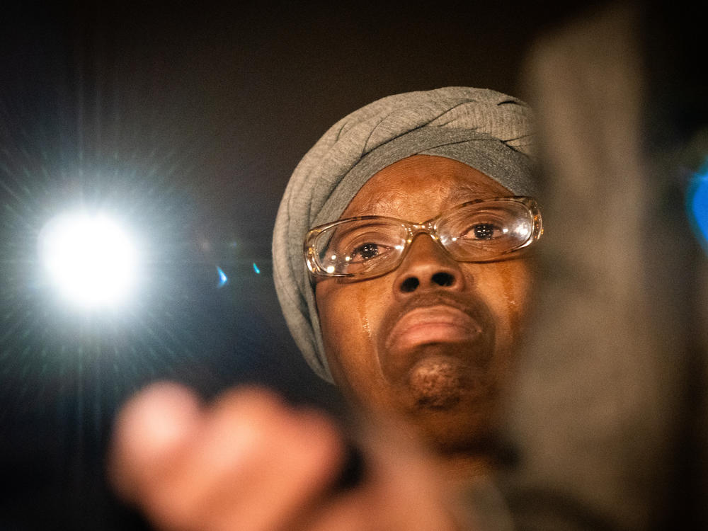 Tears fall from Sheneen McClain's face outside the Adams County Justice Center Friday night, Dec. 22, after a jury found two paramedics guilty on lesser charges in the death of her son, Elijah McClain.