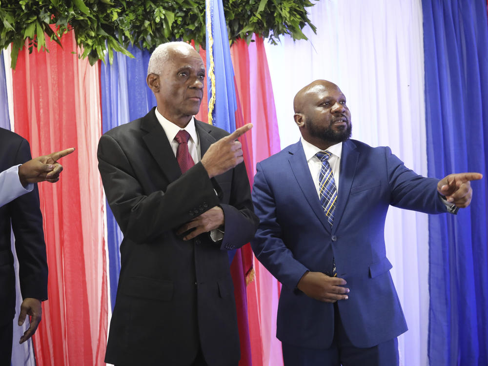 Edgard Leblanc Fils, left, and Smith Augustin prepare to pose for a group photo with the transitional council after it named Fils as its president in Port-au-Prince, Haiti, Tuesday, April 30, 2024.