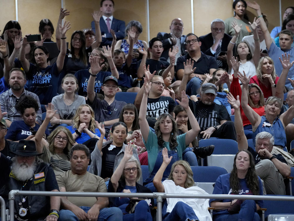 Spectators in the gallery of the Arizona Senate Wednesday wave their hands in silent disapproval. The Senate voted to repeal a near-total ban on abortion was passed in 1864.