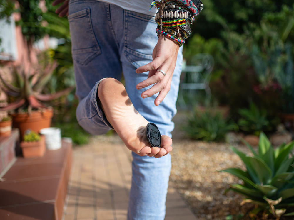 Photographer Tommy Trenchard, a regular contributor to this blog, picks up a lens cap with his toes.