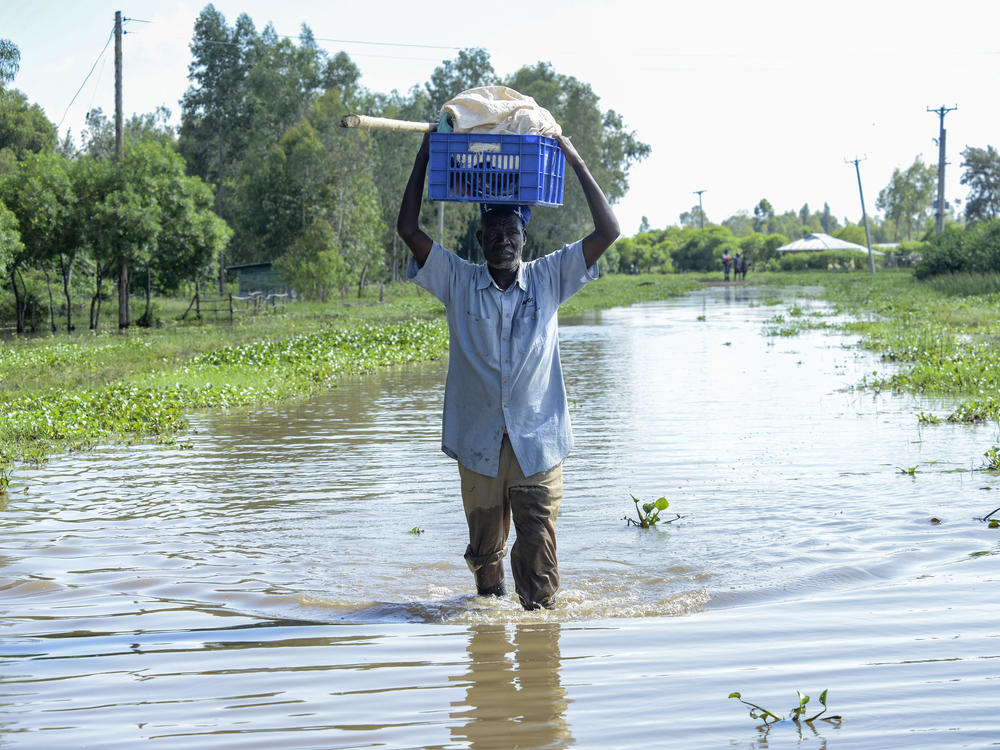 A man walks through floodwaters in Kisumu, Kenya, April 17.