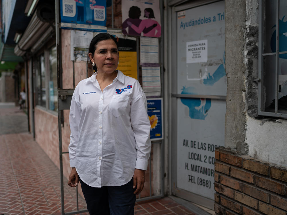 Glady Cañas, president of Ayudándoles a Triunfar, stands outside the organization's offices in Matamoros, Mexico.