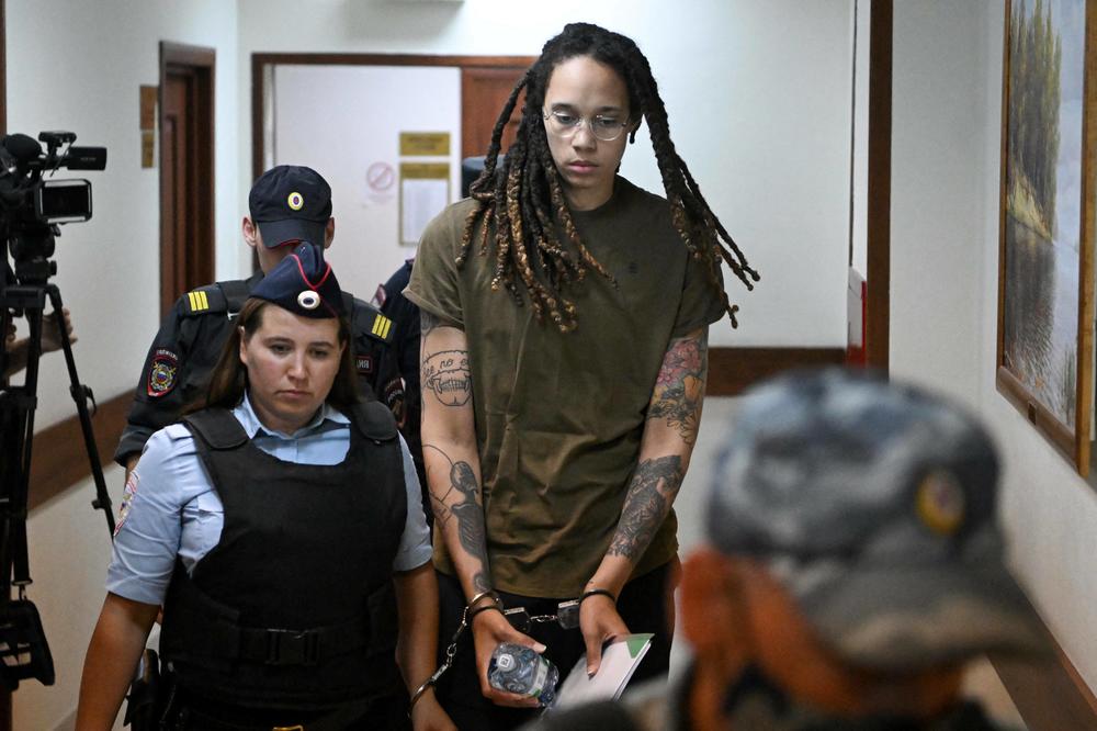 Griner being escorted by police before a hearing during her trial in Khimki, outside Moscow in August 2022.