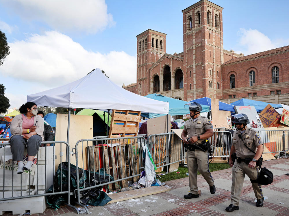 CA Highway Patrol officers walk on the University of California, Los Angeles campus on May 1, 2024 near a pro-Palestinian encampment. Hundreds of protesters have since been arrested on UCLA's campus.