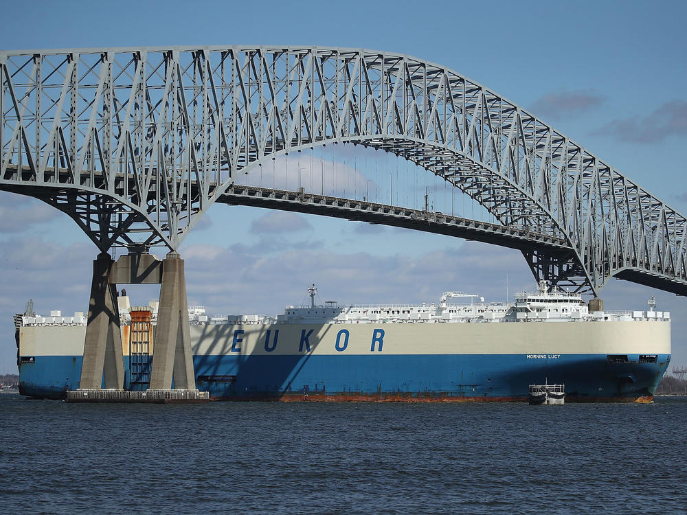 An outbound cargo ship passes under the Francis Scott Key Bridge in Baltimore in 2018. A cargo vessel slammed into the steel-truss bridge on March 26 of this year, causing it to collapse.